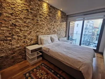 a bedroom with a brick wall and a bed at CTS Taksim Elysium Residence Dublex D-84 in Istanbul