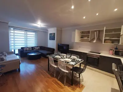 a kitchen and living room with a table and chairs at CTS Taksim Elysium Residence Dublex D-84 in Istanbul