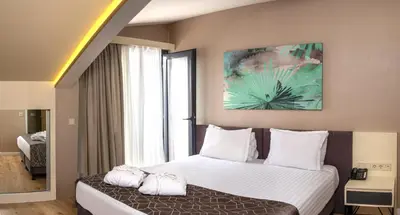 a bedroom with a large bed with white pillows at Elm Suite Hotel in Istanbul