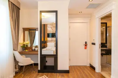a hotel room with a mirror and a bed at Eastanbul Suites in Istanbul
