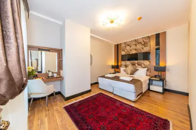 a bedroom with a bed and a red rug at Eastanbul Suites in Istanbul