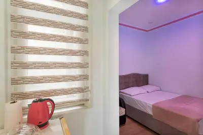a small bedroom with a bed and a window at TAXİM ELEGANCE SUİTES in Istanbul