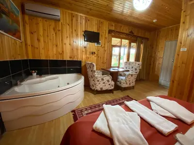 a bathroom with a tub and a bed and a sink at Ağva Green River Hotel in Agva