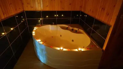 a bathroom with a tub with lights in it at Ağva Green River Hotel in Agva