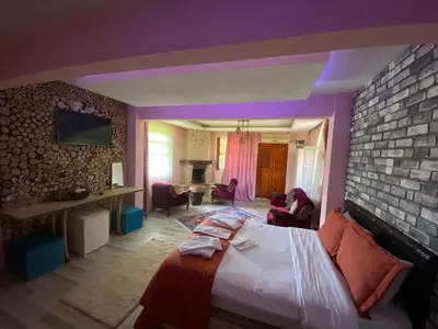 a bedroom with a bed and a brick wall at Ağva Green River Hotel in Agva