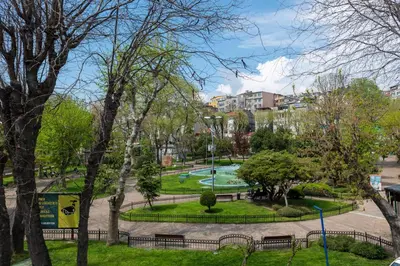a park with benches and trees and buildings at Enderun by Otantik Suites in Istanbul