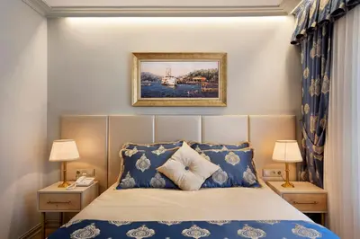a bedroom with a bed with blue and white pillows at Güner Business Hotel in Istanbul