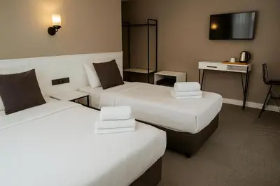 a hotel room with two beds and a desk at Blue Point Hotel in Istanbul