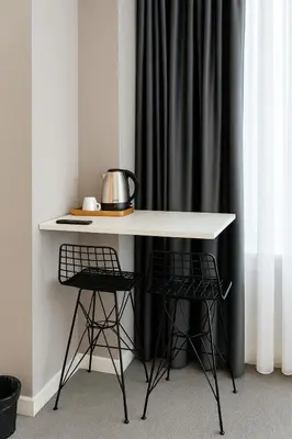 a white table with two chairs and a tea kettle on it at Blue Point Hotel in Istanbul