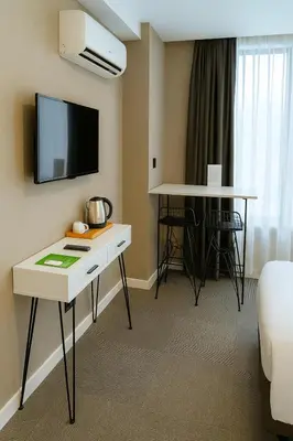 a hotel room with a desk and a tv on the wall at Blue Point Hotel in Istanbul