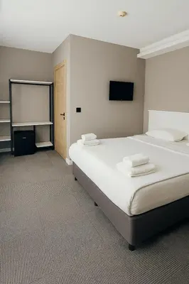 a bedroom with a large bed and a tv at Blue Point Hotel in Istanbul