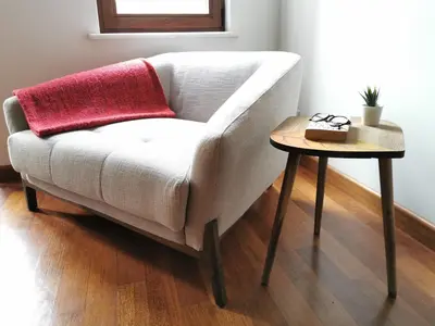 a white couch with a red pillow next to a table at Ottobalat in Istanbul