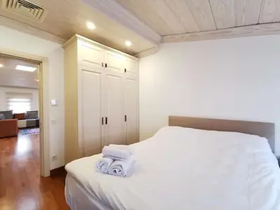 a bedroom with a white bed with towels on it at Ottobalat in Istanbul