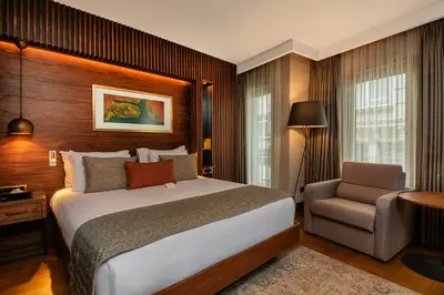 a hotel room with a bed and a chair at Levni Plus Hotel in Istanbul