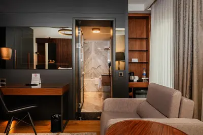 a living room with a couch and a desk at Levni Plus Hotel in Istanbul