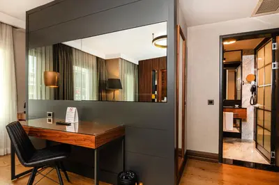 a home office with a desk and a mirror at Levni Plus Hotel in Istanbul
