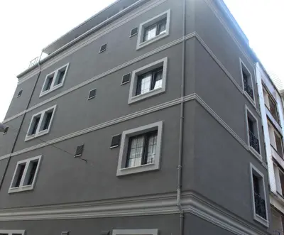 a gray building with white windows on the side of it at Good Night Hotel Istanbul in Istanbul