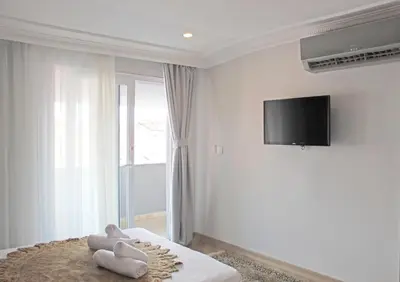a bedroom with a bed with a tv on the wall at Good Night Hotel Istanbul in Istanbul