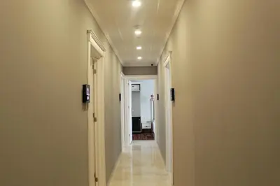 a hallway with white walls and a long corridor at Good Night Hotel Istanbul in Istanbul