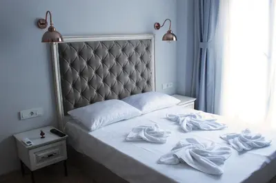 a bedroom with a bed with white towels on it at Good Night Hotel Istanbul in Istanbul