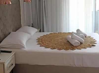 a bed with three towels on top of it at Good Night Hotel Istanbul in Istanbul