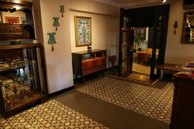 a living room with a door and a room with a rug at Nomade Old City Hotel in Istanbul