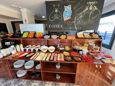 a coffee shop with a table full of food at Nomade Old City Hotel in Istanbul
