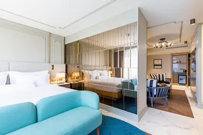 a bedroom with a bed and a living room at Stayso The House Hotel in Istanbul