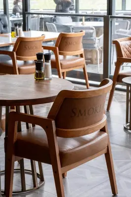 a row of wooden chairs and tables in a restaurant at Stayso The House Hotel in Istanbul