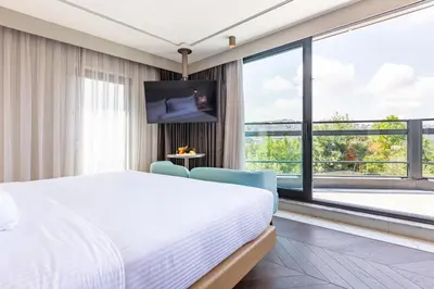 a bedroom with a bed and a large window at Stayso The House Hotel in Istanbul