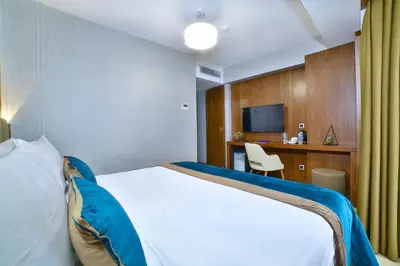 a hotel room with a bed and a desk at The Tango Hotel Taksim in Istanbul