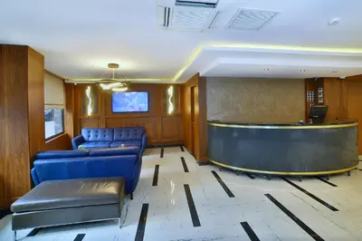 a waiting room with blue chairs and a bar at The Tango Hotel Taksim in Istanbul