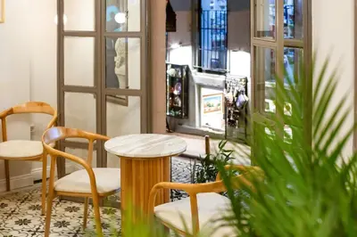 a table and two chairs in a room with a window at Hotel Des Arts Galata in Istanbul