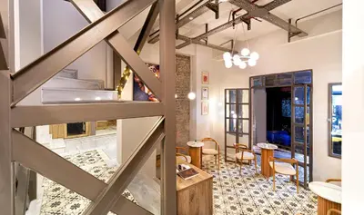 a room with a staircase and a table and chairs at Hotel Des Arts Galata in Istanbul