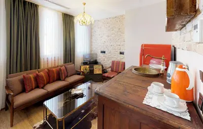 a living room with a couch and a table at Hotel Des Arts Galata in Istanbul