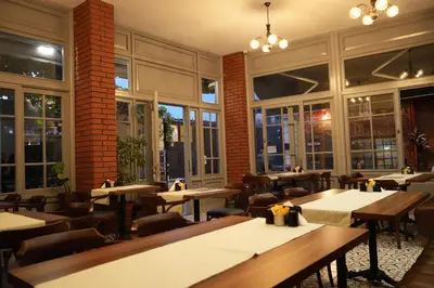 a restaurant with tables and chairs and large windows at madame roza in Istanbul