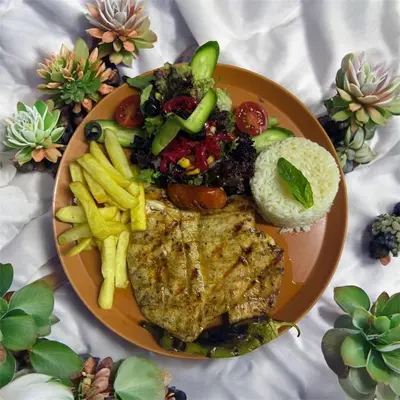 a plate of food with meat and vegetables and french fries at madame roza in Istanbul