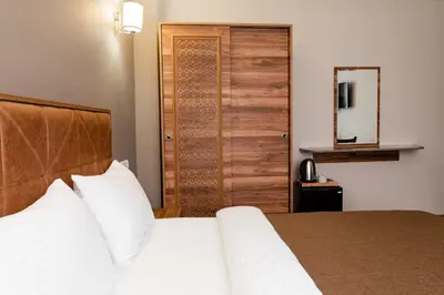 a bedroom with a bed and a wooden door at madame roza in Istanbul
