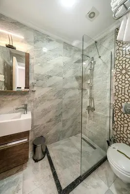 a bathroom with a shower and a toilet and a sink at Beyazit Palace Hotel in Istanbul