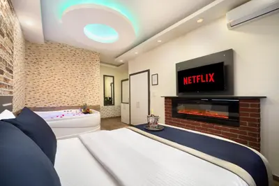a living room with a bed and a fireplace at İstanbul Hotel & Suites in Istanbul