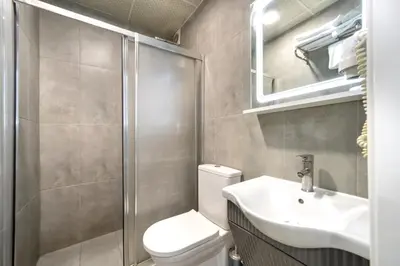 a bathroom with a toilet and a sink and a shower at İstanbul Hotel & Suites in Istanbul