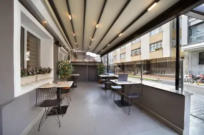 a balcony with tables and chairs in a building at İstanbul Hotel & Suites in Istanbul
