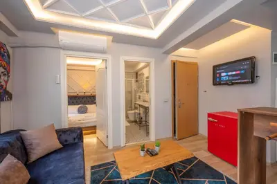 a living room with a couch and a tv on a ceiling at Dorne Suite Taksim Hotel in Istanbul
