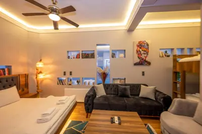 a living room with a couch and a ceiling fan at Dorne Suite Taksim Hotel in Istanbul