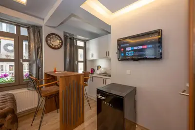 a living room with a tv on the wall at Dorne Suite Taksim Hotel in Istanbul