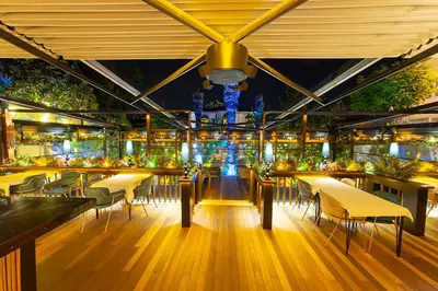 a restaurant with tables and chairs and lights at No2 Hotel By Şükrü in Adalar