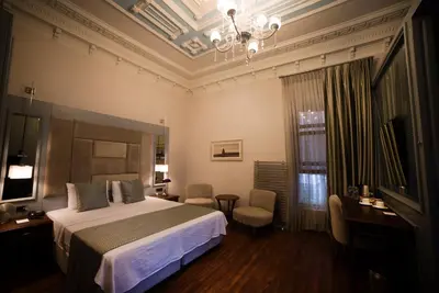 a bedroom with a bed and a chandelier at No2 Hotel By Şükrü in Adalar