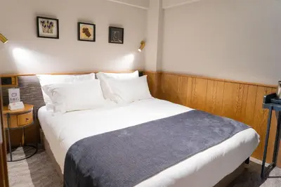 a bedroom with a large bed with white sheets and pillows at MEG HOTEL in Istanbul