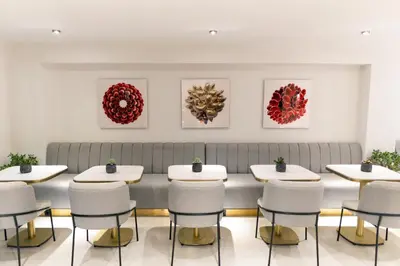 a room with tables and chairs and paintings on the wall at MEG HOTEL in Istanbul