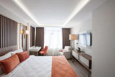 a hotel room with a bed and a desk and a television at Sherry Suites Karaköy in Istanbul